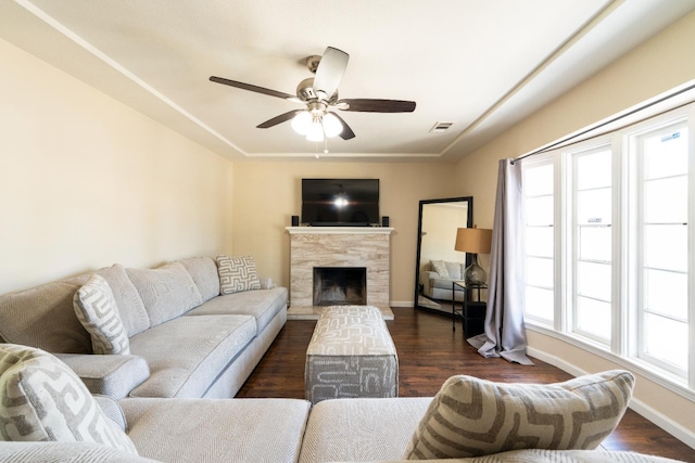 4115 E Montecito Ave, Fresno, CA 93702 - living area featuring a ceiling fan, a fireplace with raised hearth, and dark wood-style floors