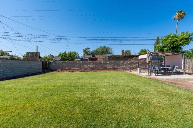 4115 E Montecito Ave, Fresno, CA 93702 - fenced backyard with a patio area