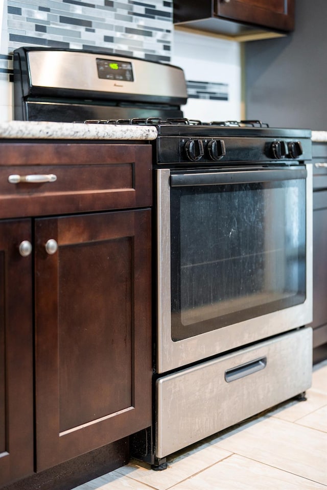 4115 E Montecito Ave, Fresno, CA 93702 - kitchen featuring stainless steel range with gas cooktop and dark brown cabinetry