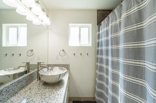 4115 E Montecito Ave, Fresno, CA 93702 - bathroom with plenty of natural light, vanity, and a chandelier