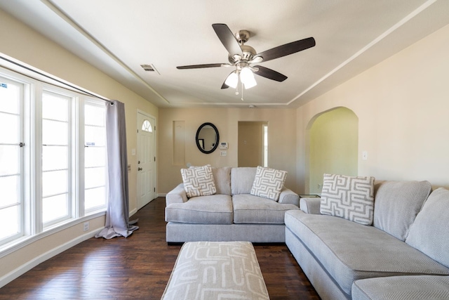 4115 E Montecito Ave, Fresno, CA 93702 - living room with dark wood-style floors, a ceiling fan, and arched walkways