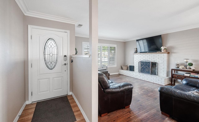 2816 Monocott, Madera, CA 93637 - entrance foyer featuring crown molding, wood finished floors, and a brick fireplace