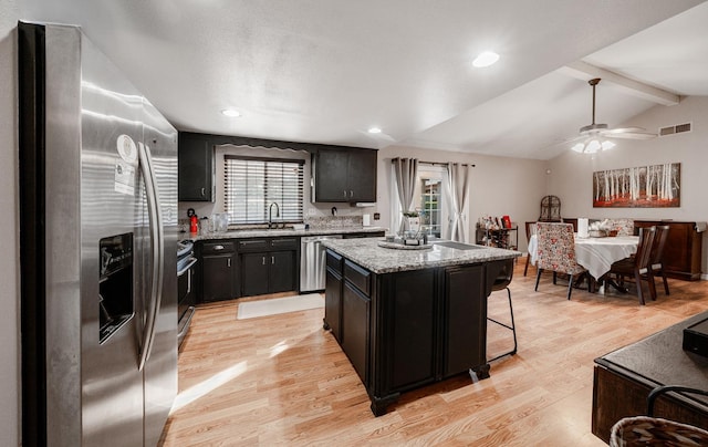 2816 Monocott, Madera, CA 93637 - kitchen featuring stainless steel appliances, dark cabinets, a center island, light wood-type flooring, and recessed lighting