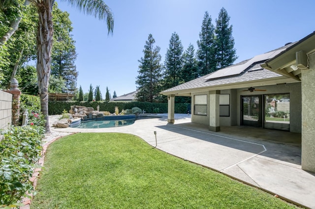 689 E Pintail Cir, Fresno, CA 93730 - fenced backyard with ceiling fan and a patio area