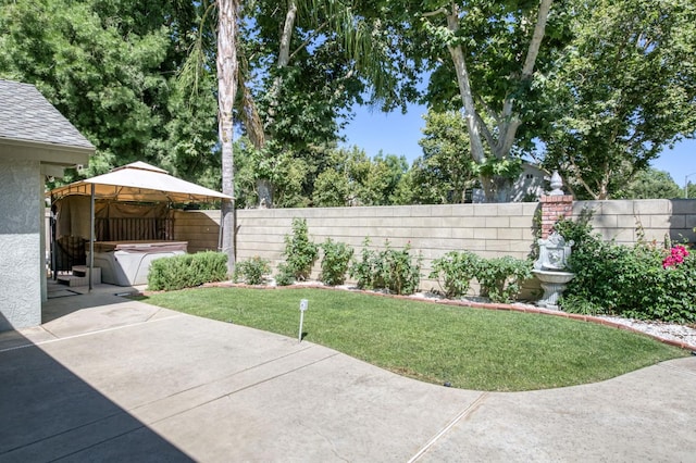 689 E Pintail Cir, Fresno, CA 93730 - fenced backyard featuring a hot tub, a patio area, and a gazebo