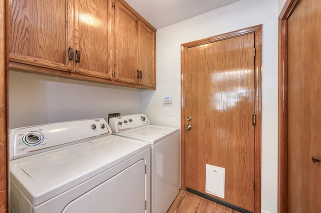 689 E Pintail Cir, Fresno, CA 93730 - laundry area with washing machine and dryer, cabinet space, and light wood finished floors