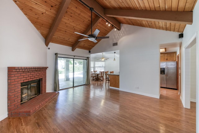 689 E Pintail Cir, Fresno, CA 93730 - unfurnished living room featuring a ceiling fan, a wooden ceiling with exposed beams, light wood-style flooring, a fireplace, and high vaulted ceiling