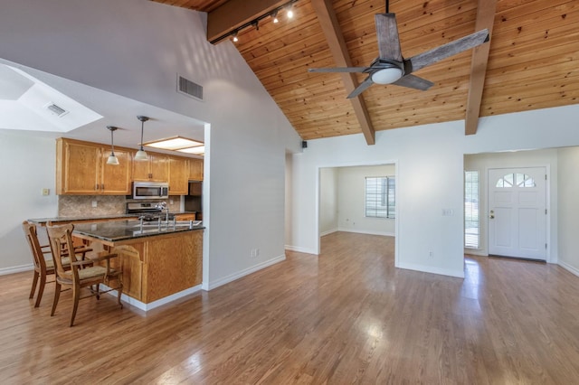 689 E Pintail Cir, Fresno, CA 93730 - kitchen featuring appliances with stainless steel finishes, track lighting, a wooden ceiling with exposed beams, ceiling fan, and light wood-style floors