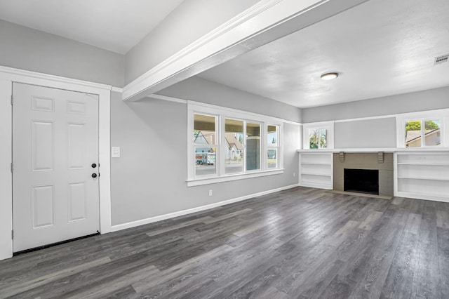 1303 N Calaveras St, Fresno, CA 93728 - unfurnished living room with dark wood-type flooring and a fireplace with flush hearth