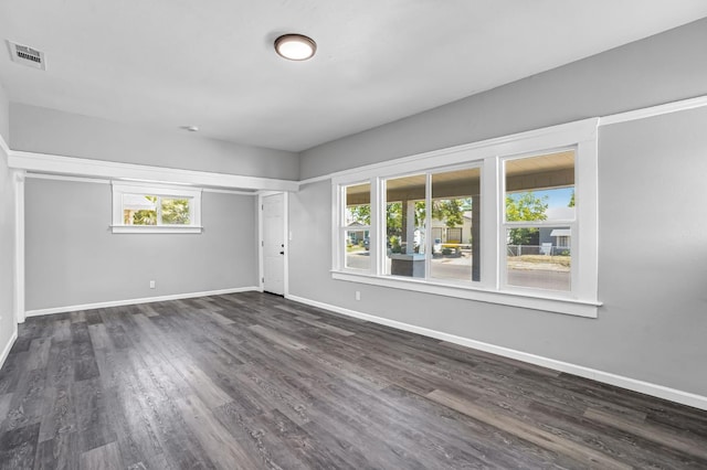 1303 N Calaveras St, Fresno, CA 93728 - empty room featuring baseboards and dark wood finished floors