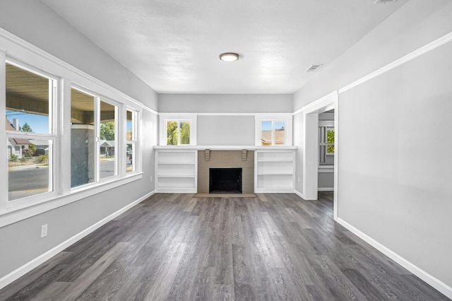 1303 N Calaveras St, Fresno, CA 93728 - unfurnished living room with dark wood finished floors and a fireplace with flush hearth