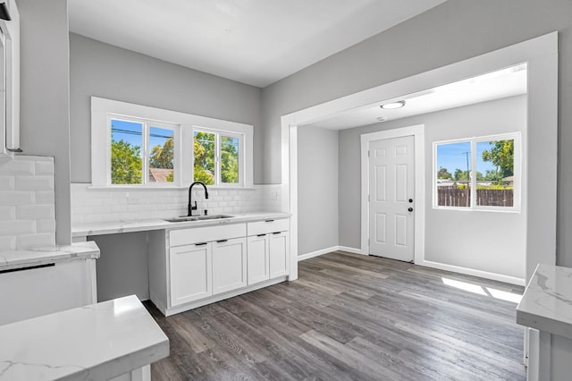1303 N Calaveras St, Fresno, CA 93728 - kitchen featuring light stone counters, backsplash, dark wood-type flooring, and white cabinetry