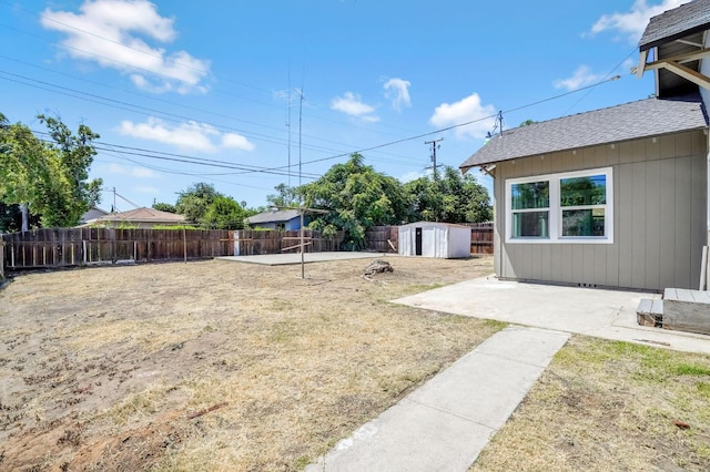 1303 N Calaveras St, Fresno, CA 93728 - fenced backyard with a storage unit and a patio area