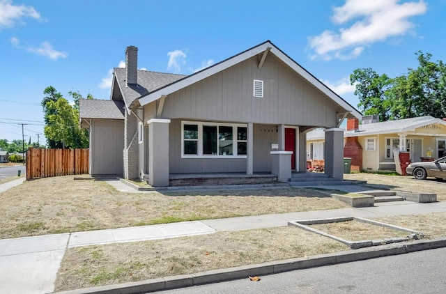 1303 N Calaveras St, Fresno, CA 93728 - ranch-style house featuring a chimney, covered porch, and roof with shingles