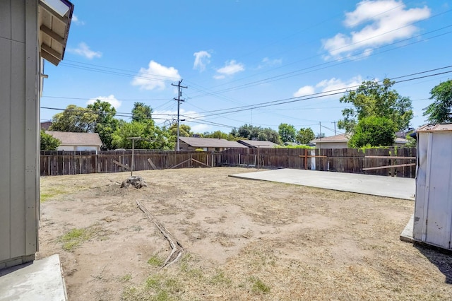 1303 N Calaveras St, Fresno, CA 93728 - fenced backyard with a patio area