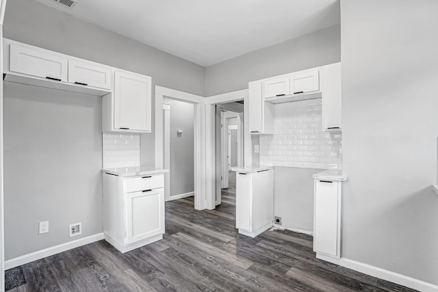 1303 N Calaveras St, Fresno, CA 93728 - kitchen featuring white cabinets, dark wood finished floors, tasteful backsplash, and light countertops