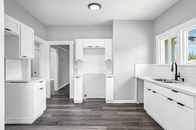 1303 N Calaveras St, Fresno, CA 93728 - kitchen with tasteful backsplash, dark wood-type flooring, and white cabinets