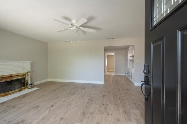 4342 E Buckingham Way, Fresno, CA 93726 - foyer entrance featuring a brick fireplace, ceiling fan, and light wood-type flooring