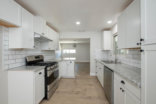 4342 E Buckingham Way, Fresno, CA 93726 - kitchen with appliances with stainless steel finishes, under cabinet range hood, backsplash, light wood-type flooring, and recessed lighting