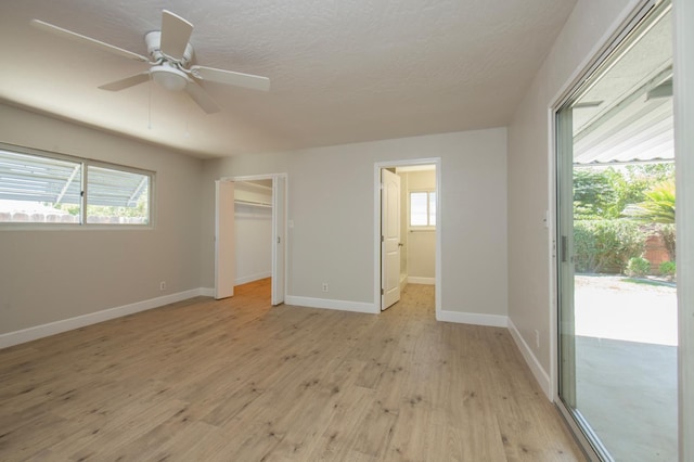 4342 E Buckingham Way, Fresno, CA 93726 - unfurnished bedroom featuring access to outside, light wood-style floors, a ceiling fan, and a walk in closet