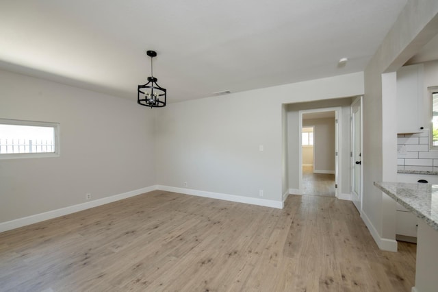 4342 E Buckingham Way, Fresno, CA 93726 - spare room featuring a chandelier and light wood finished floors