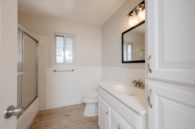 4342 E Buckingham Way, Fresno, CA 93726 - bathroom featuring vanity, wood finished floors, and bath / shower combo with glass door