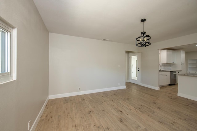 4342 E Buckingham Way, Fresno, CA 93726 - unfurnished living room featuring a chandelier and light wood finished floors