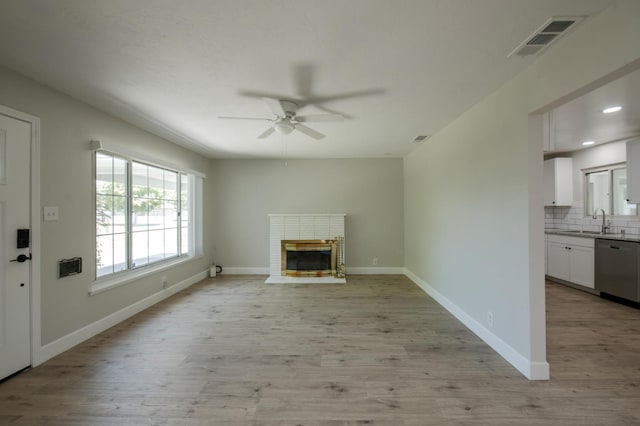 4342 E Buckingham Way, Fresno, CA 93726 - unfurnished living room featuring ceiling fan, light wood finished floors, a fireplace, and recessed lighting