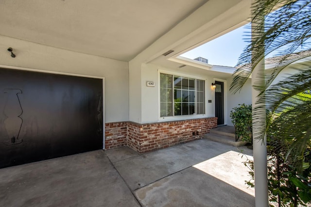 4342 E Buckingham Way, Fresno, CA 93726 - doorway to property featuring brick siding, stucco siding, and a patio area