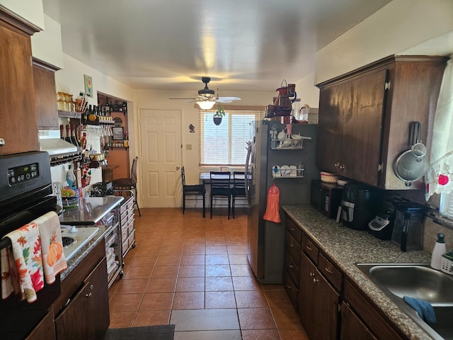 432 Brimmer Rd, Merced, CA 95341 - kitchen featuring ceiling fan, wall oven, freestanding refrigerator, black microwave, and dark brown cabinetry
