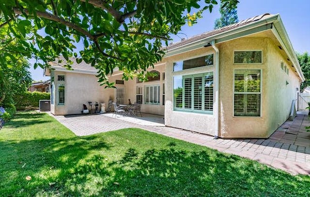 5214 N Via Trevi, Fresno, CA 93711 - rear view of house with stucco siding, a patio, and a lawn