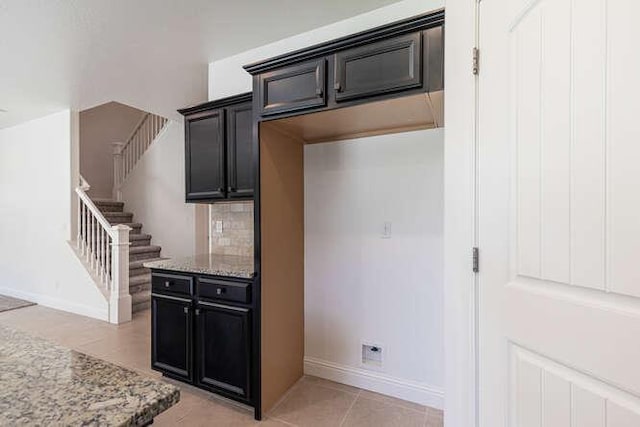 2166 Junipero Ave, Clovis, CA 93619 - kitchen with light stone countertops, tasteful backsplash, and dark cabinets