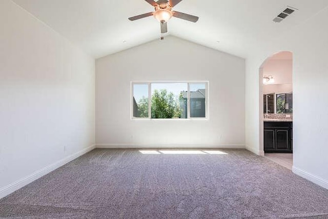 2166 Junipero Ave, Clovis, CA 93619 - spare room featuring arched walkways, carpet, a ceiling fan, and vaulted ceiling