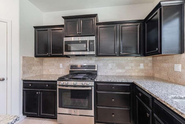2166 Junipero Ave, Clovis, CA 93619 - kitchen featuring stainless steel appliances, light stone counters, and backsplash