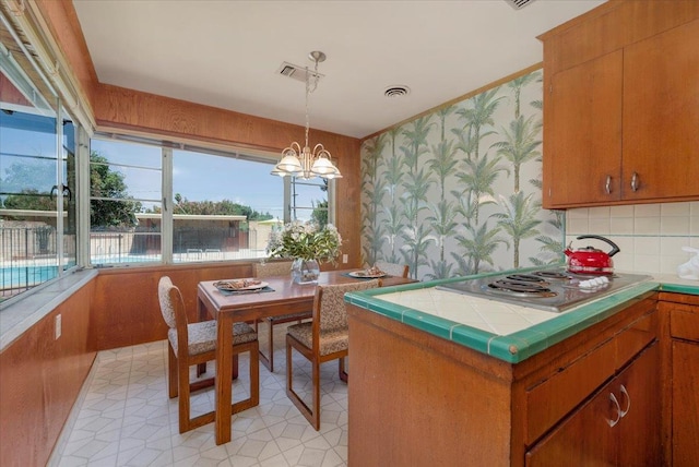 5481 E Geary St, Fresno, CA 93727 - dining space featuring wallpapered walls and a chandelier
