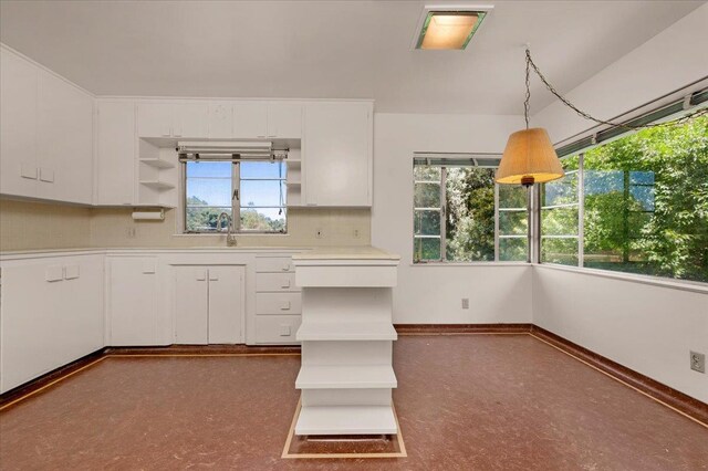 5481 E Geary St, Fresno, CA 93727 - kitchen featuring open shelves, healthy amount of natural light, white cabinets, and light countertops