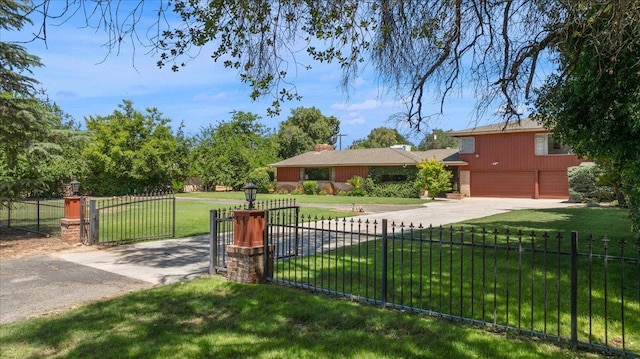 5481 E Geary St, Fresno, CA 93727 - view of front of home with concrete driveway, a fenced front yard, a garage, and a gate