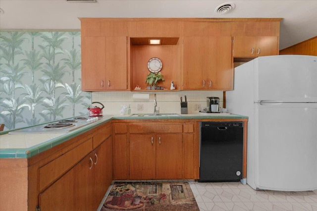 5481 E Geary St, Fresno, CA 93727 - kitchen with white appliances, tile counters, decorative backsplash, and brown cabinetry