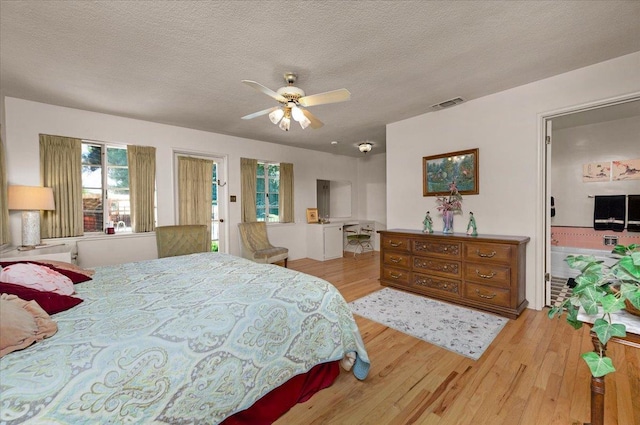 5481 E Geary St, Fresno, CA 93727 - bedroom with wood finished floors, a textured ceiling, and a ceiling fan