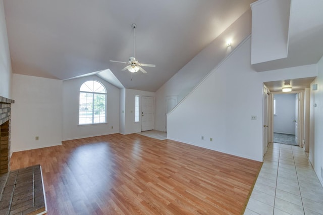 9340 N Jackson Ave, Fresno, CA 93720 - unfurnished living room with a ceiling fan, light wood-style flooring, a fireplace, and lofted ceiling