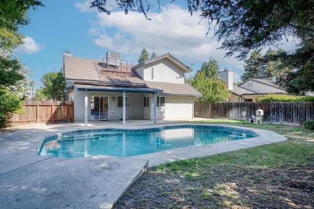 9340 N Jackson Ave, Fresno, CA 93720 - rear view of house with a patio, stucco siding, a fenced backyard, and a tiled roof