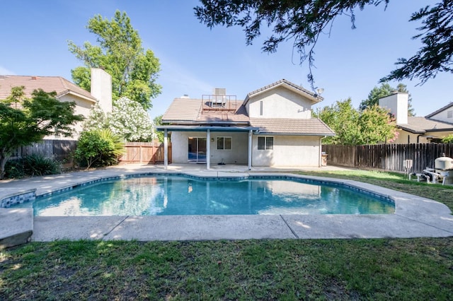 9340 N Jackson Ave, Fresno, CA 93720 - rear view of house featuring a tile roof, a fenced backyard, stucco siding, and a patio
