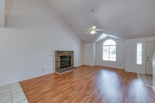 9340 N Jackson Ave, Fresno, CA 93720 - unfurnished living room featuring ceiling fan, light wood-style floors, vaulted ceiling, and a fireplace