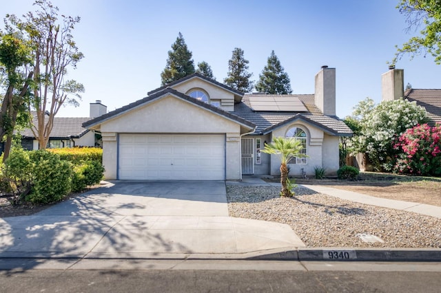 9340 N Jackson Ave, Fresno, CA 93720 - ranch-style home featuring stucco siding, driveway, a garage, a tiled roof, and a chimney