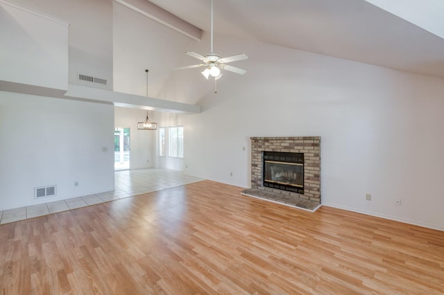 9340 N Jackson Ave, Fresno, CA 93720 - unfurnished living room featuring light wood-style flooring, high vaulted ceiling, a fireplace, ceiling fan, and beam ceiling
