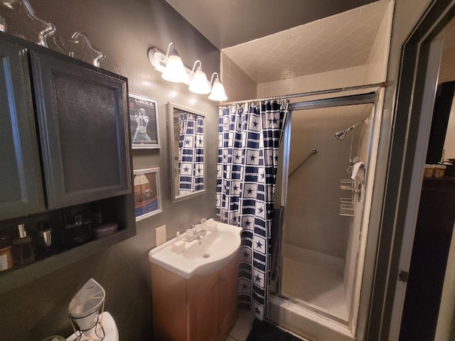 bathroom with a shower stall and vanity