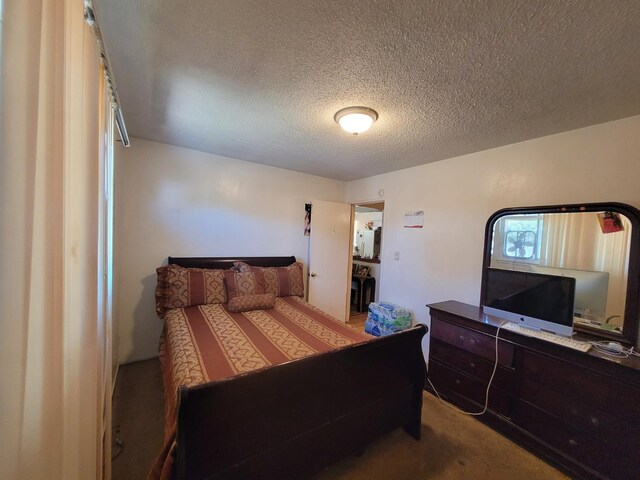 carpeted bedroom with a textured ceiling