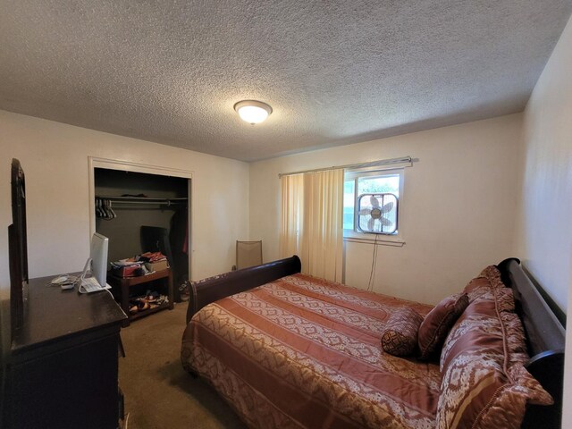 carpeted bedroom featuring a closet and a textured ceiling