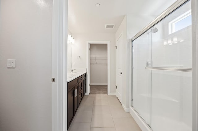 834 Amanecer Ave, Clovis, CA 93619 - full bathroom with a shower stall, vanity, a spacious closet, and tile patterned floors