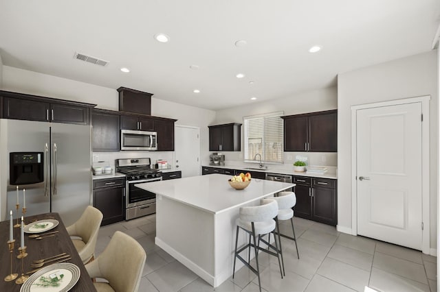 834 Amanecer Ave, Clovis, CA 93619 - kitchen featuring appliances with stainless steel finishes, light countertops, a kitchen breakfast bar, a center island, and recessed lighting